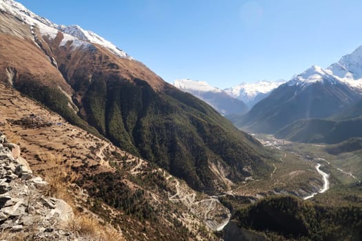 View onto the steep trail from the valley of the Marsyangdi River, Upper, Lower Pisang to the traditional mountain village of Ghyaru, Annapurna Circuit Trek, Nepal 2022