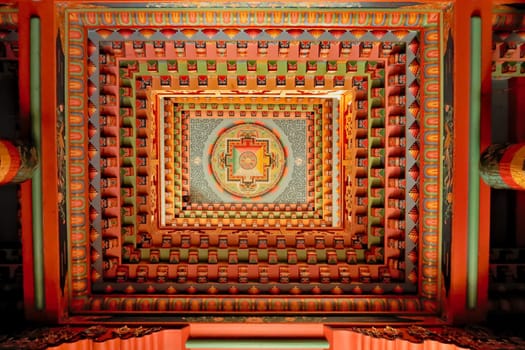 The colorful ceiling inside the tibetan buddhist temple of Upper Pisang, painted with patterns, details, elements in many bright colors, Annapurna Circuit Trek, Nepal 2022