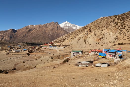 View onto the traditional mountain village of Ngawal, the snow capped peak of Chulu East is rising in the background, Annapurna Circuit Trek, Nepal 2022