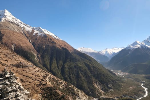 View onto the steep trail from the valley of the Marsyangdi River, Upper, Lower Pisang to the traditional mountain village of Ghyaru in front of Pisang Peak, Annapurna Circuit Trek, Nepal 2022