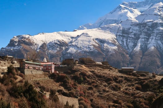 Looking back up to the traditional mountain village of Ngawal in front of the snow capped peak of Annapurna II, Annapurna Circuit Trek, Nepal 2022