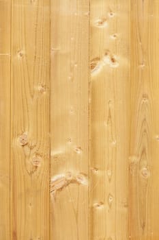 Light brown wooden wall on a construction fence with knotholes, Germany