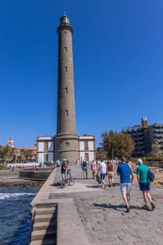 Gran Canaria, Spain: March 20, 2024: People near the Maspalomas Lighthouse in Gran Canaria Canary Island.This highest lighthouse on the island,a landmark in this important tourist destination