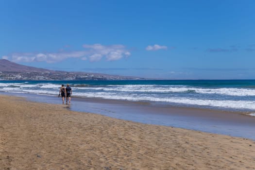 Gran Canaria, Spain - March 20, 2024: People visit Playa Ingles beach in Maspalomas, Gran Canaria. Spain