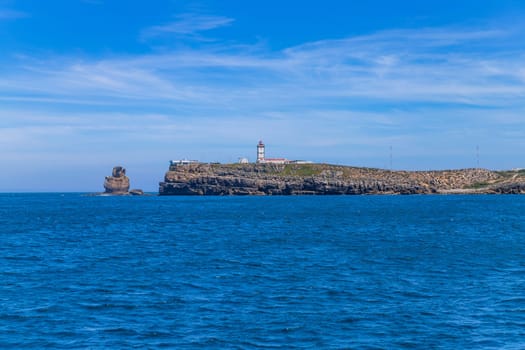 Lighthouse and cliffs of Carvoeiro cape in Peniche, Atlantic coast, Portugal