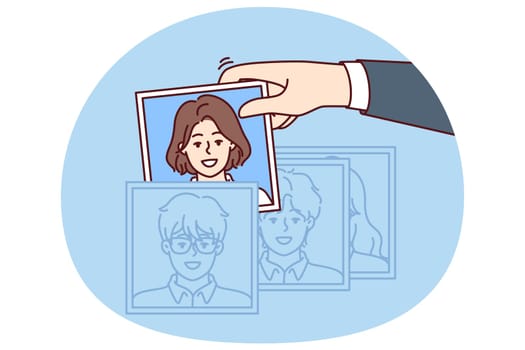Hand of recruiter making selection of employees for company assembling team in HR division corporation. Person is engaged in recruitment, working as HR manager and finding people for current vacancies