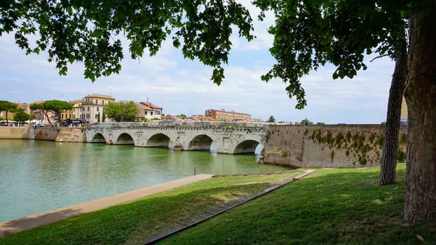 Historical roman Tiberius Bridge over Marecchia river in Rimini at Italy