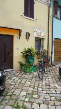 Rimini, Italy - June 25, 2024: Art installation on wall at Borgo San Giuliano typical street with low and colorful houses at Rimini, Italy