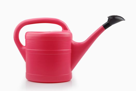Pink plastic watering can isolated on white background