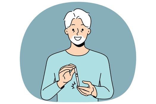 Elderly man uses glucometer to measure level insulin in blood and smiles, rejoicing at easing diabetes. Gray-haired grandfather with glucometer recommends fighting diabetes and taking care of health