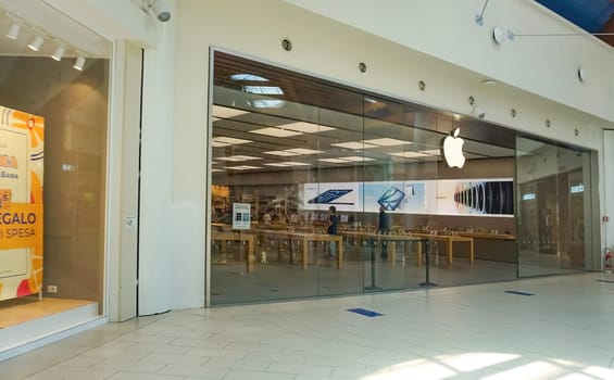 Rimini, Italy - June 25, 2024: Le Befane Centre of Commerce. This is the biggest shopping center in Rimini. Unidentified people are shopping. Apple Inc.store