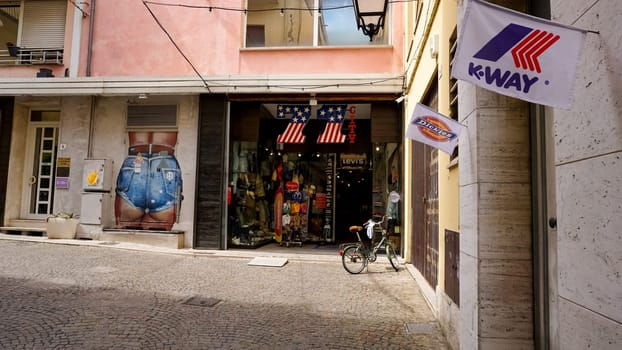 Rimini, Italy - June 25, 2024: Shop front of clothing retail store in shopping mall, shutters half drawn. Levi's store