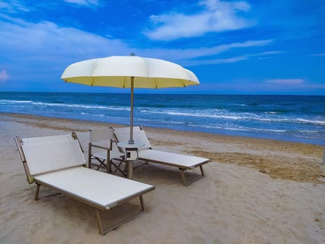 Summer. The sunbeds and parasols on the empty beach