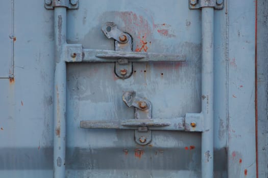 Container door lock, uncompromised security of high-end shipping and cargo handling. Steel locking mechanism provides top-notch protection for secured containers from any unauthorized access, ensuring the safety of your marine transportation and sea freight. Metal rust and paint background