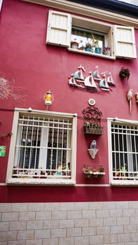 Rimini, Italy - June 25, 2024: Art installation on wall at Borgo San Giuliano typical street with low and colorful houses at Rimini, Italy