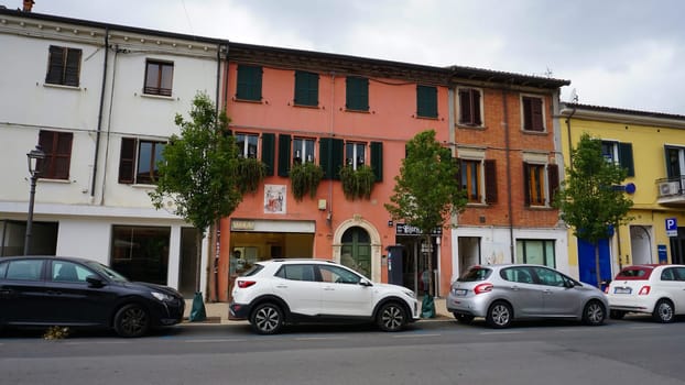 Rimini, Italy - June 25, 2024: Mural on wall at typical street with low and colorful houses at Rimini, Italy