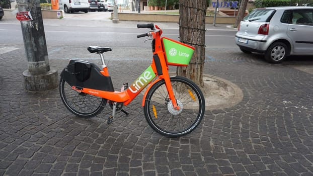 Rimini, Italy - June 25, 2024: Lime app sign brand and logo text on bicycle rent bike e-Scooter rental electric scooter company service of shared bikes
