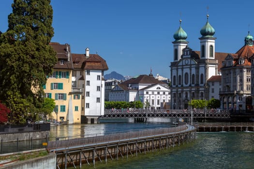 The city of Lucerne (Luzern) in Switzerland. View of the Jesuit Church over the Nadelwerk (Needle Dam) a 19th century device used to control the flow of thr River Reuss.