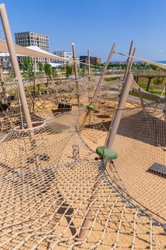 Large public city playground with slides and climbing frame, panorama of modern urban area