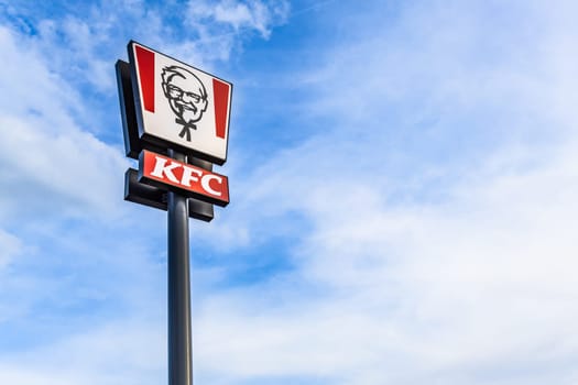 KFC Kentucky Fried Chicken fast food restaurant logo sign. American fastfood signboard against blue sky
