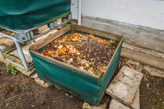 Compost bin in a garden, using kitchen and green waste to prepare organic fertilizer