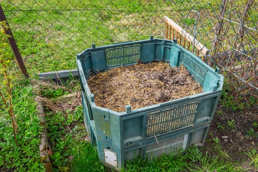 Compost bin in a garden, using kitchen and green waste to prepare organic fertilizer