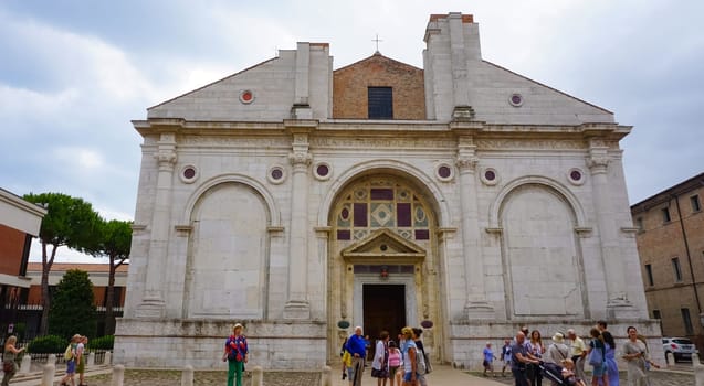 Rimini, Italy - June 25, 2024: The people going near Tempio Malatestiano or IItalian Malatesta Temple is the cathedral church of Rimini, Italy.