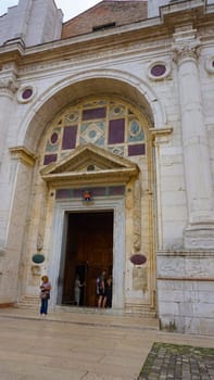 Rimini, Italy - June 25, 2024: The people going near Tempio Malatestiano or IItalian Malatesta Temple is the cathedral church of Rimini, Italy.