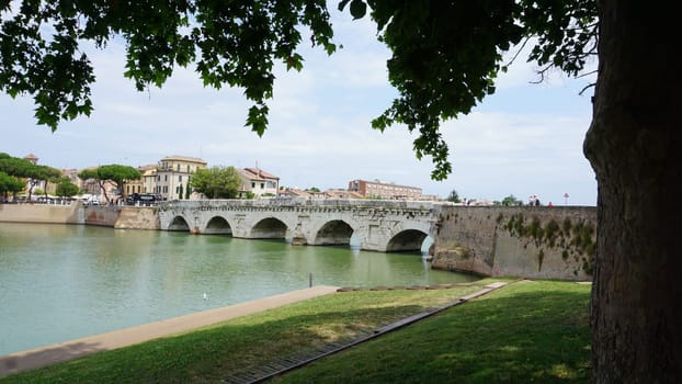 Historical roman Tiberius Bridge over Marecchia river in Rimini at Italy