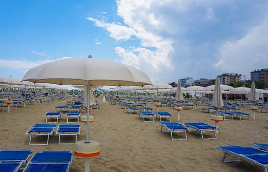 Summer. The sunbeds and parasols on the empty beach