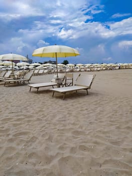 Summer. The sunbeds and parasols on the empty beach