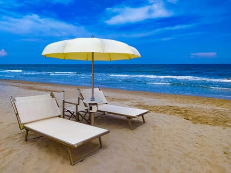 Summer. The sunbeds and parasols on the empty beach