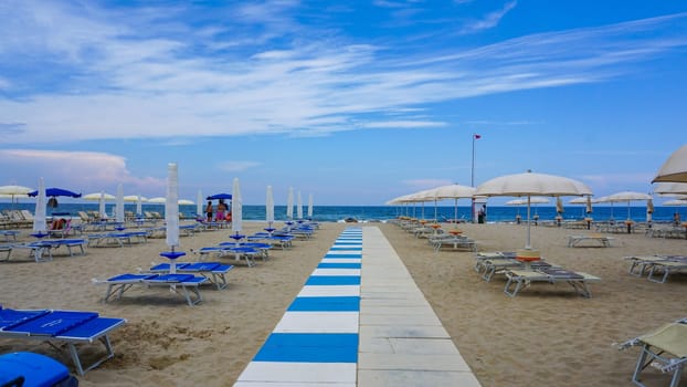 Summer. The sunbeds and parasols on the empty beach