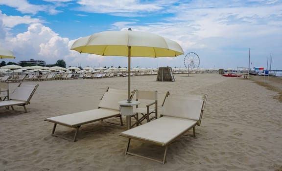 Summer. The sunbeds and parasols on the empty beach