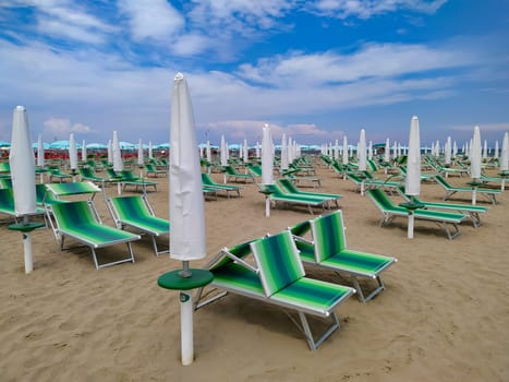 Summer. The sunbeds and parasols on the empty beach