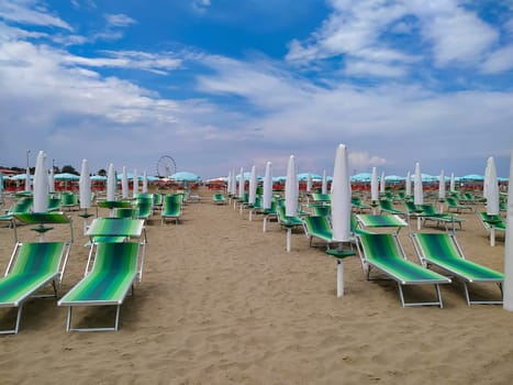 Summer. The sunbeds and parasols on the empty beach