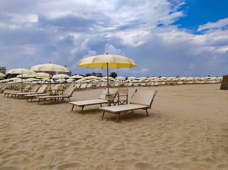 Summer. The sunbeds and parasols on the empty beach