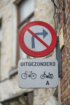 Traffic sign right turn prohibited, except cyclists and mopeds class A in Bruges in Belgium