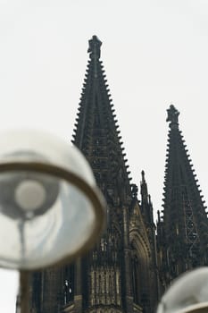 View of Cologne Cathedral in Germany from a special angle with a lantern in the foreground