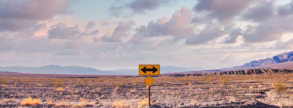 Direction sign in the desert under a blue sky. Concept of uncertain, risk, choice, decision, problem