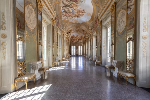 Genova, Italy - 6 August 2023: Royal Palace museum interior. Luxury marble, gallery with windows and mirrors.