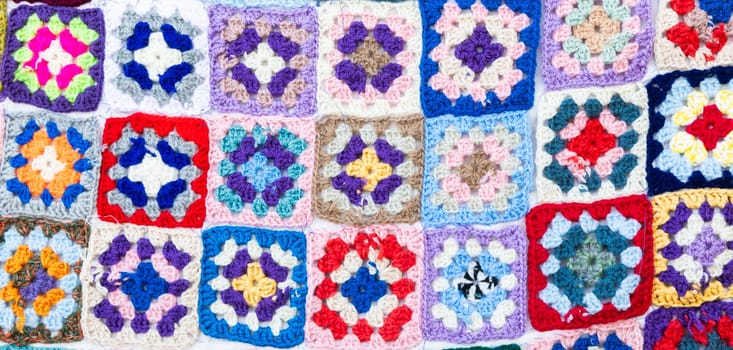 Multi colored blanket in wool, geometric background, retro decorative pattern