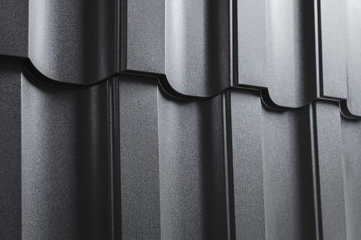 Close-up view modular tile effect roof panel. Lightweight galvanised steel roofing sheet. Traditional metal shingle tiles. Popular profiled metallic pantile mimic clay or concrete slate