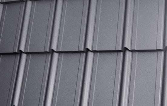 Close-up view modular tile effect roof panel. Lightweight galvanised steel roofing sheet. Traditional metal shingle tiles. Popular profiled metallic pantile mimic clay or concrete slate