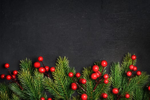 Christmas background border with christmas pine tree decor on vintage dark table. Top view. Winter holiday greeting card design. Happy new year banner.