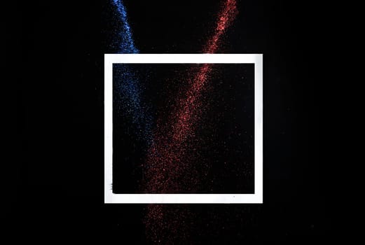 Creative frame concept with neon glitter splash trail on black background. Minimal flat lay design with star dust on dark backdrop. Holiday party modern style trend 2021.