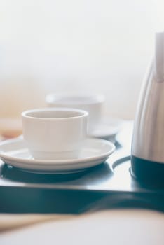 Morning breakfast with black coffee in bedroom. Two cups of coffee on bed in luxury hotel honeymoon suite. Romantic weekend for two.