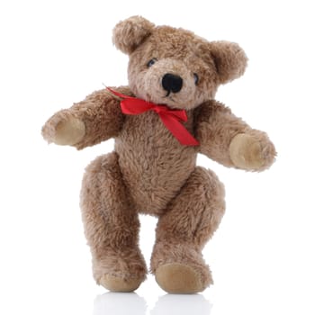 A Brown Teddy Bear with a red bow standing up