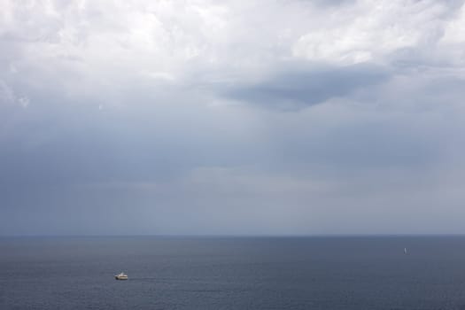 lonely cutter in the sea under a cloudy sky,Lighting before a storm in the Adriatic Sea.