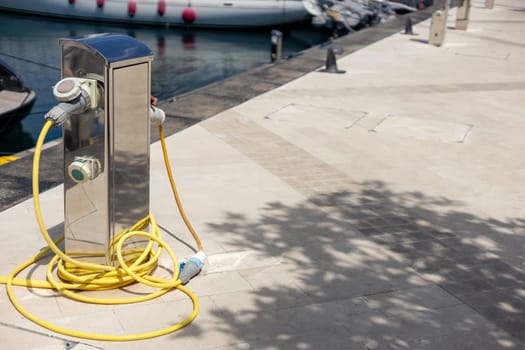 Charging station for boats. Electrical outlets for charging boats in the harbor on the pier by the sea.